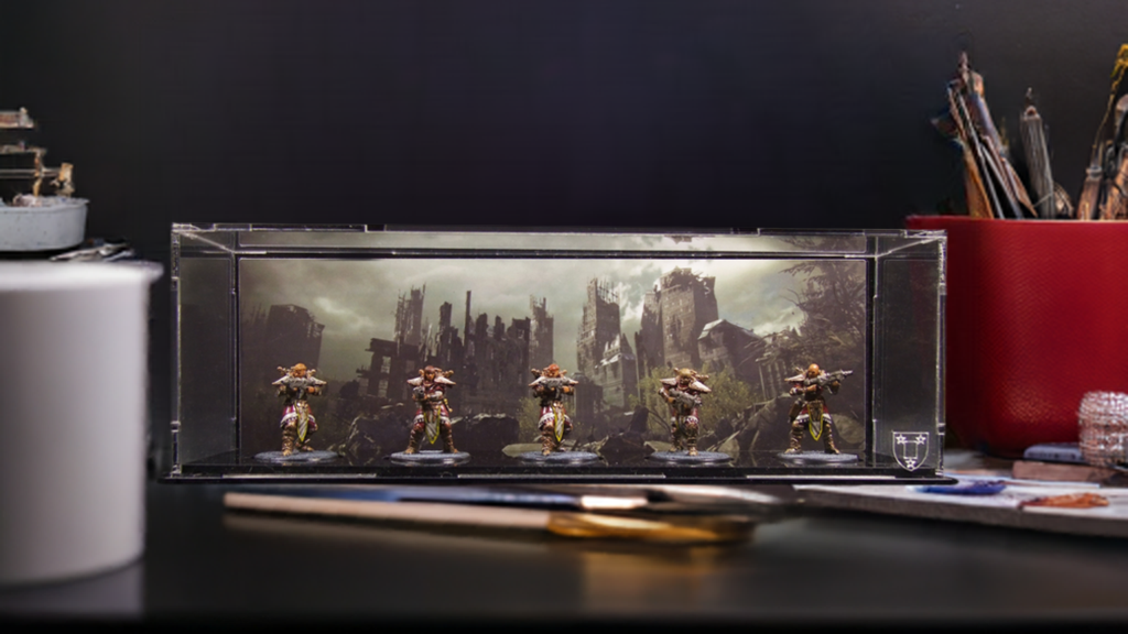 Miniature figures in a clear display case on a desk with a dark background